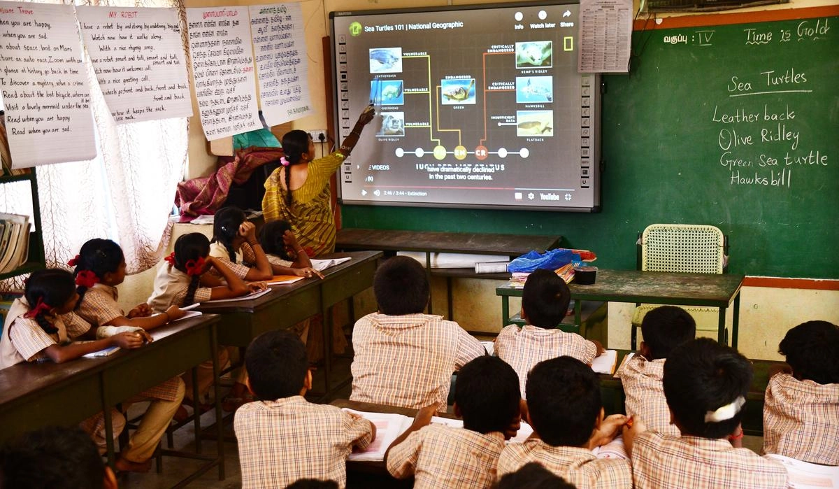 Teacher explaining the students about a diagram being displayed on smart screen